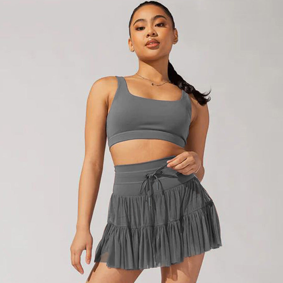 Mini-jupe taille haute pour femme avec plis et short intégré