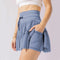 Mini-jupe taille haute pour femme avec plis et short intégré